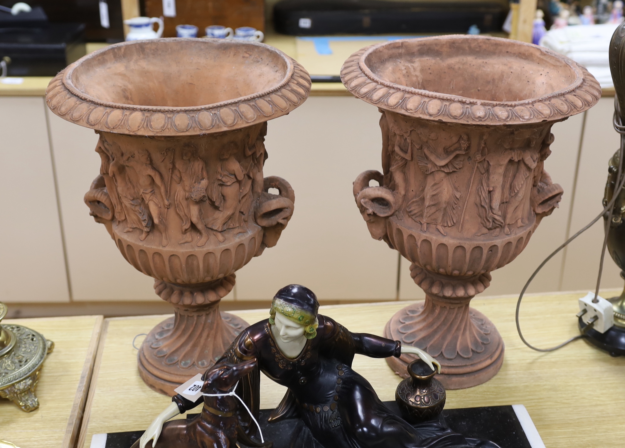A pair of terracotta neo classical urns, 46cm